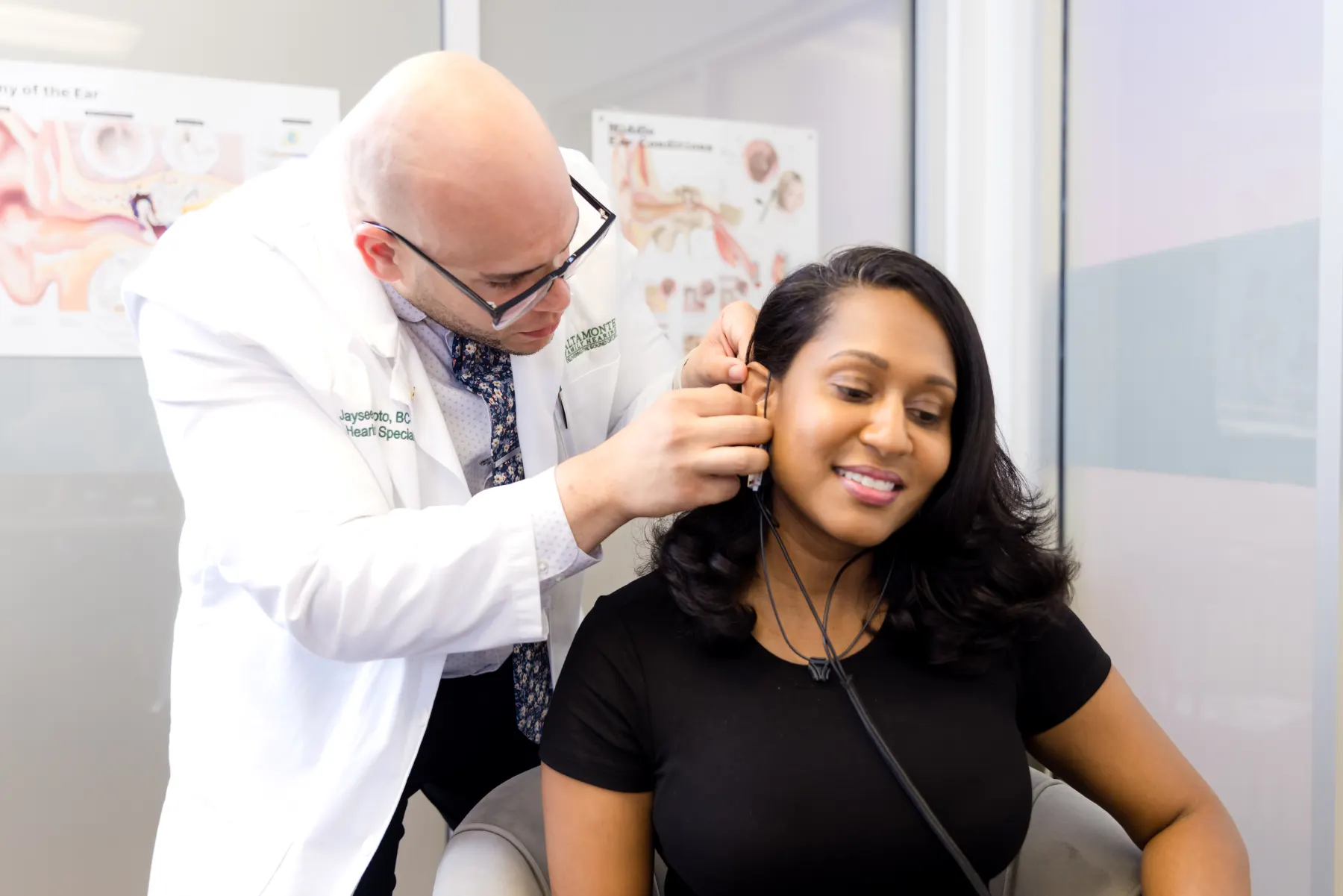 Jaysee placing the Real Ear Measurement probe tube in a patient's ear