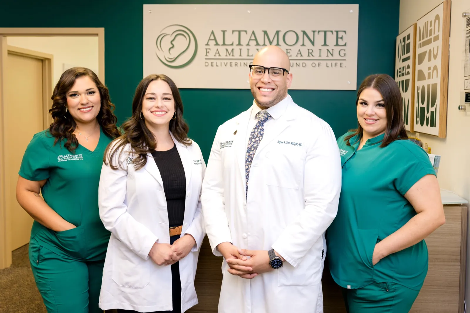 Jaysee, Toni, Grace and Francesca in front of the Altamonte Family Hearing sign